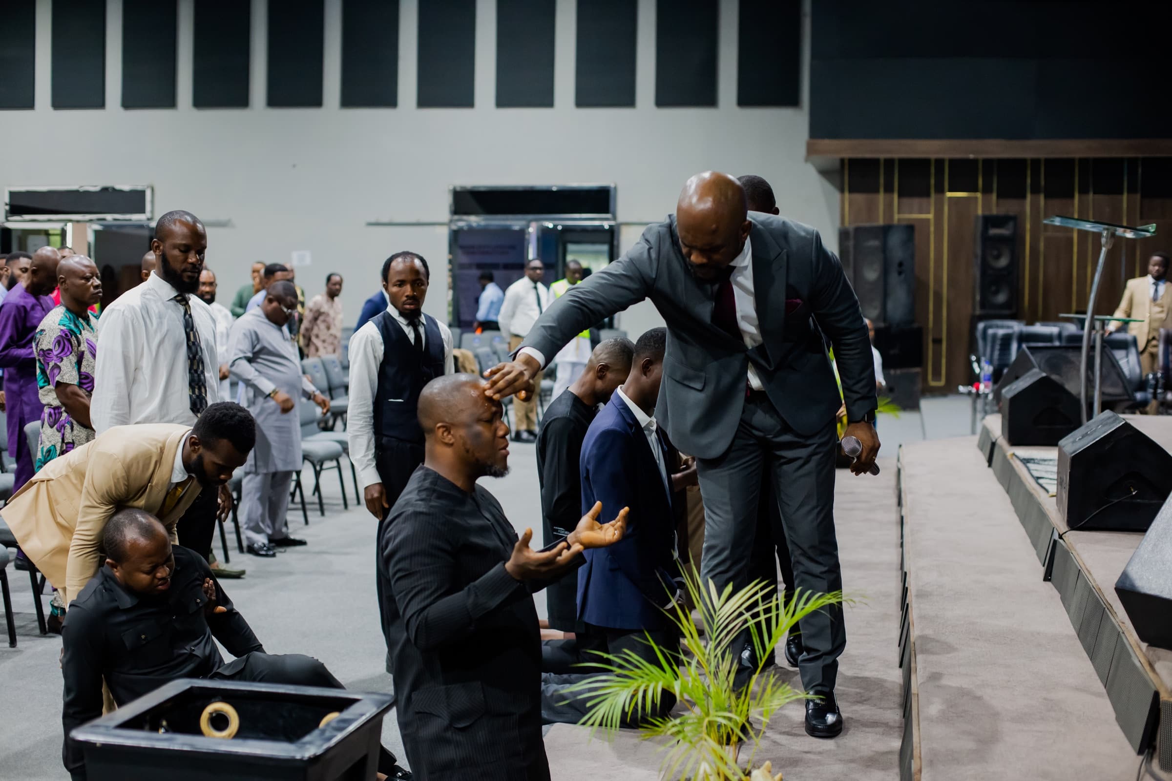 A brother helped up after prayer at the Men's Convention