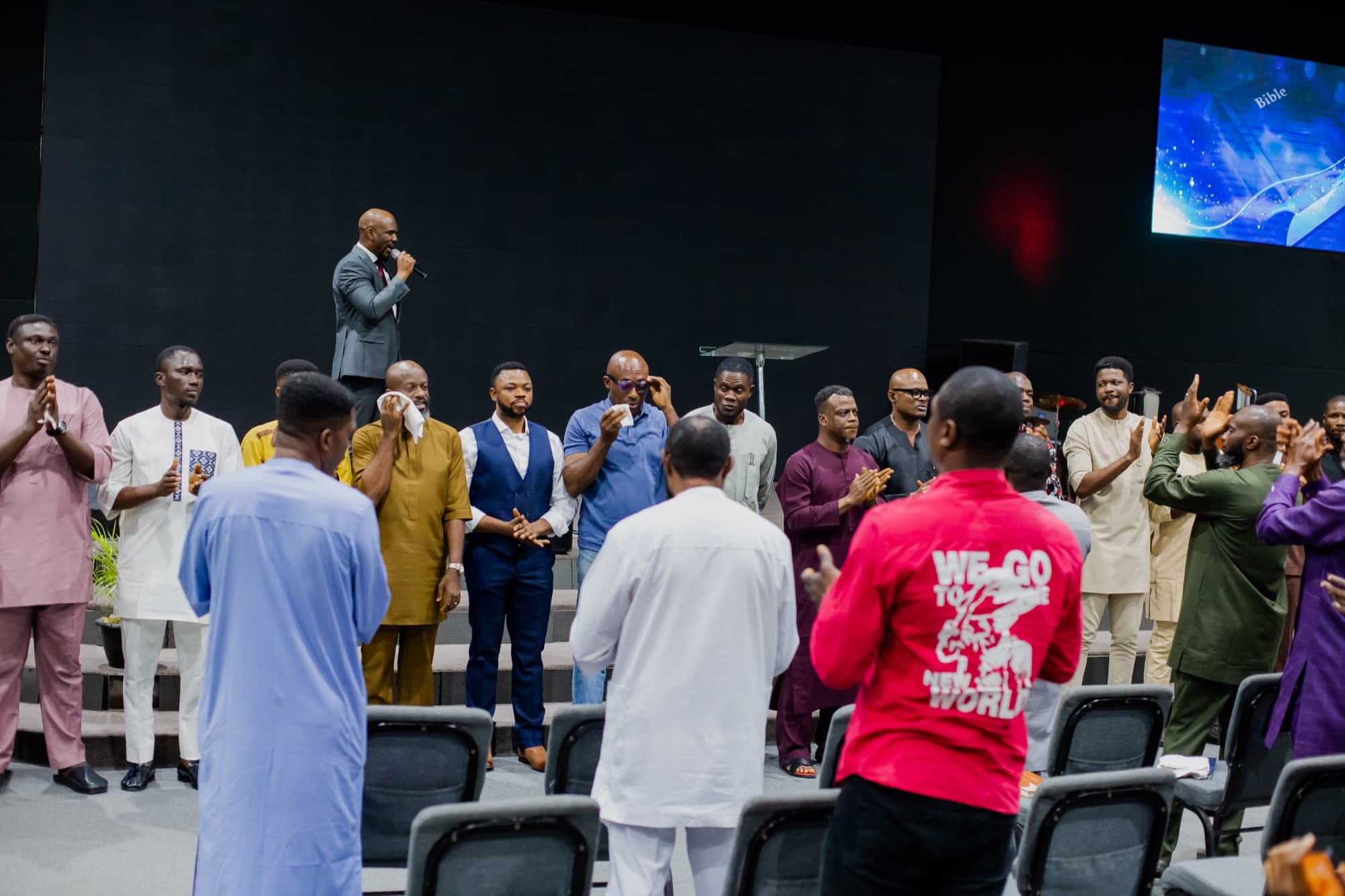 Brothers celebrating on stage at the Men's Convention